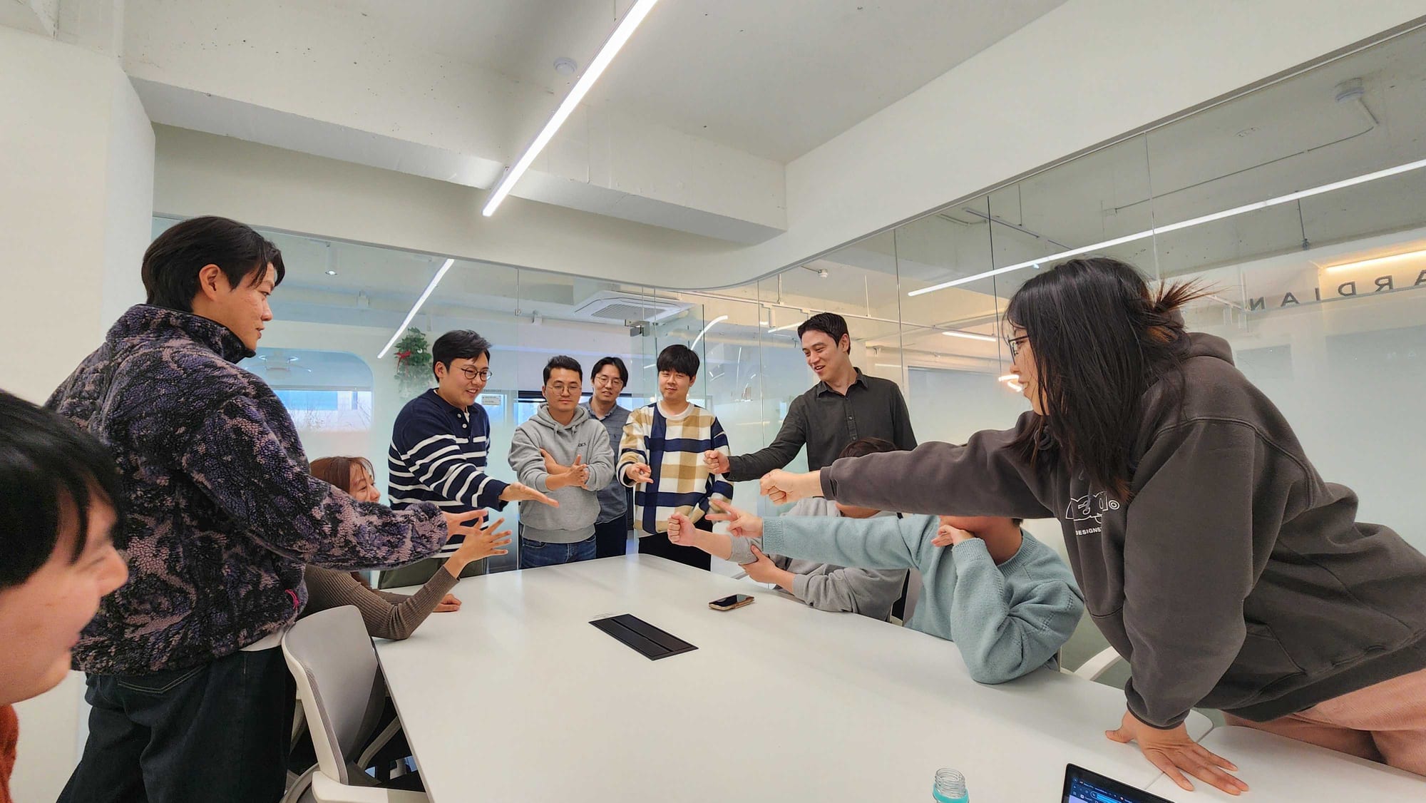 The Seoul team playing a game around the meeting table